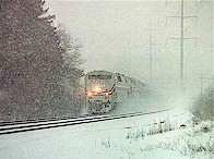 An easbound Amtrak barrels through CP Maple, approaching the West Glendale crossing at 50 mph in a snowstorm one afternoon in late December 1999.