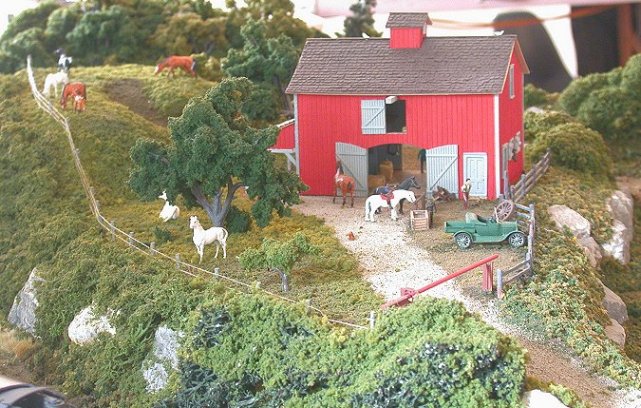 a white stallion admires a freight passing on the tracks below