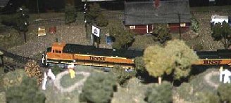Golfers pause on the par 2 hole as a BNSF freight passes on the branch line. 16K