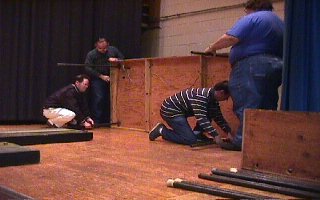 Members installing the legs on an end section. 41K