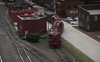 A pair of Rock Island Geeps leads a freight out of the street trackage. 52K