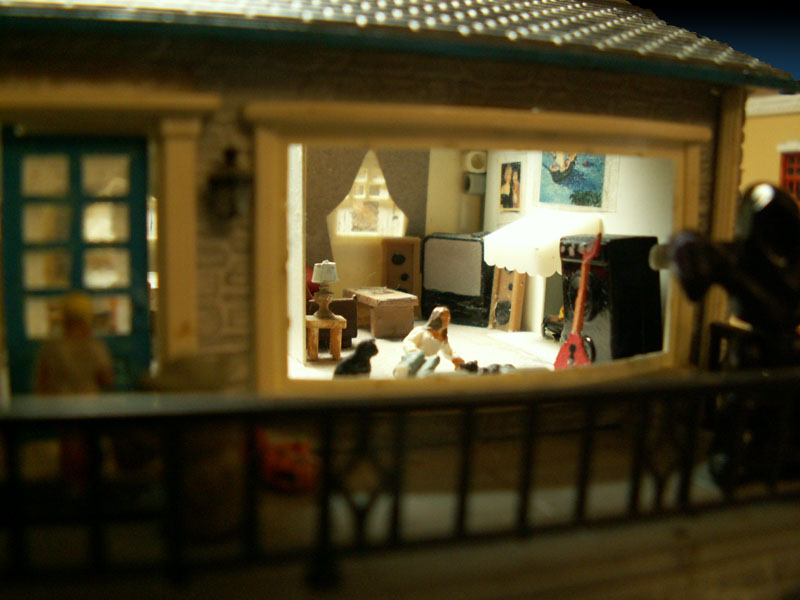 Daughter lying on the floor with the cats. Custom made flying V guitar 