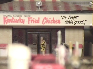 A happy customer finishes off her meals as she exits