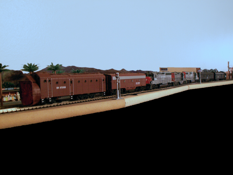 A pair of back to back rotary snow plows with a trio of geeps head up 