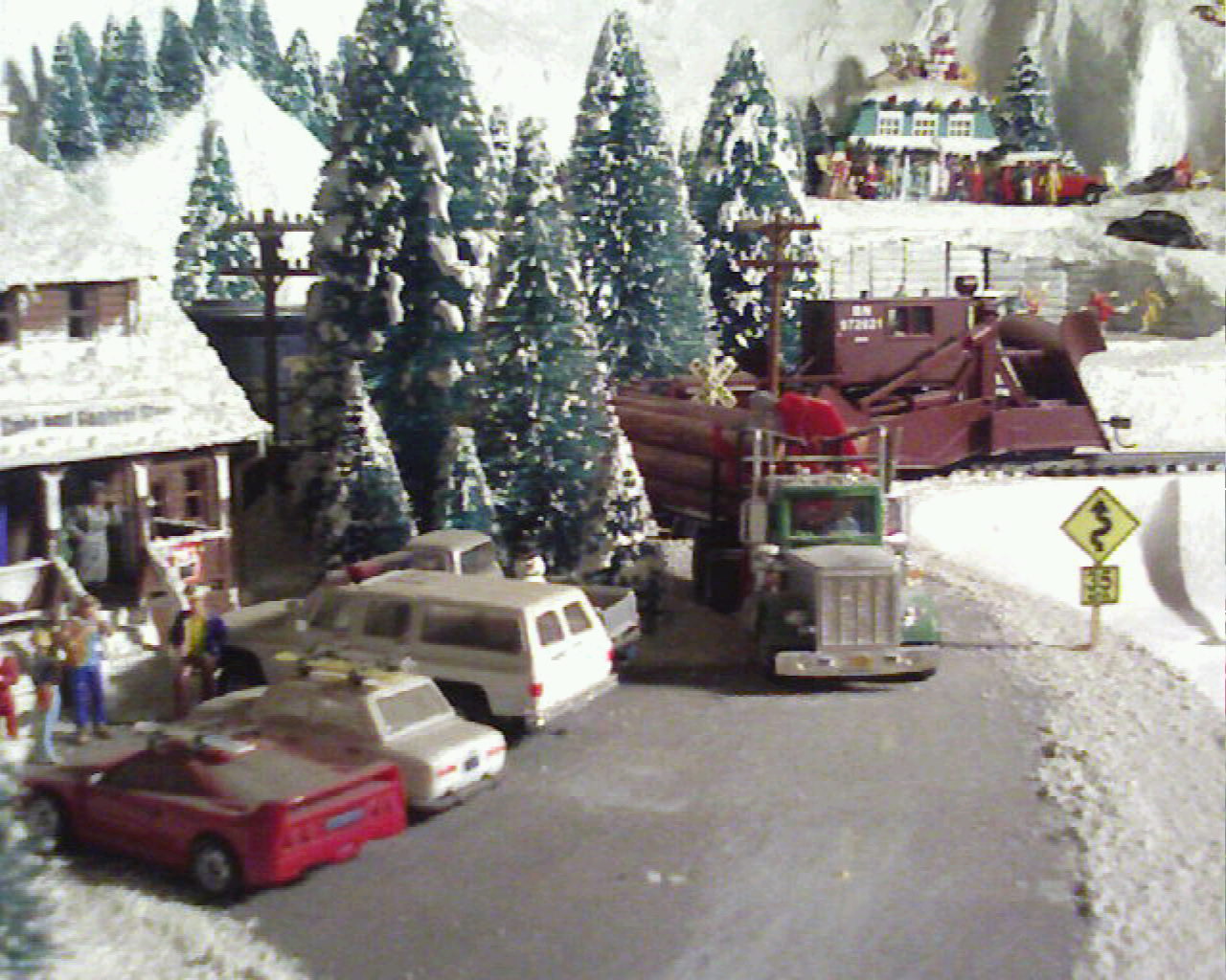A log truck on a curvy snow covered road  on Wolf Mountain