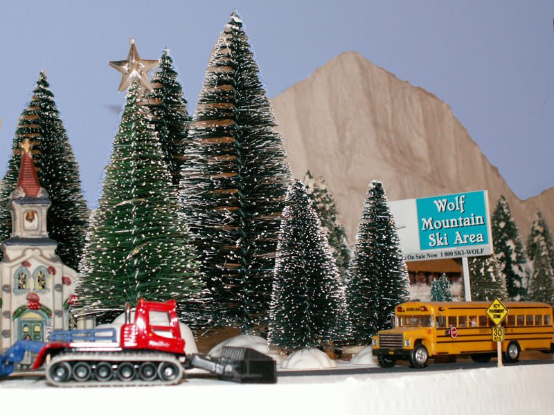 A snow groomer from the ski area smoothes a path for skiers next to the main 
