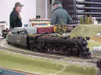 The RASG club's latest acquisition, an American Models 4-8-4 Northern class locomotive in Santa Fe livery, is on the point of a freight train.